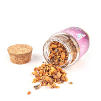 Natural Siamese Benzoin incense resin in a glass jar.