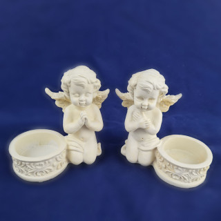 Two angels with candle holders