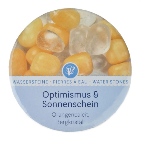 Cardboard box containing orange calcite and rock crystal gemstones for revitalizing drinking water.